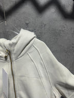 Off-white zip-up hoodie shoulder and hood detail with metal zipper