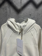 Cream zip-up hoodie with hood and visible zipper hardware