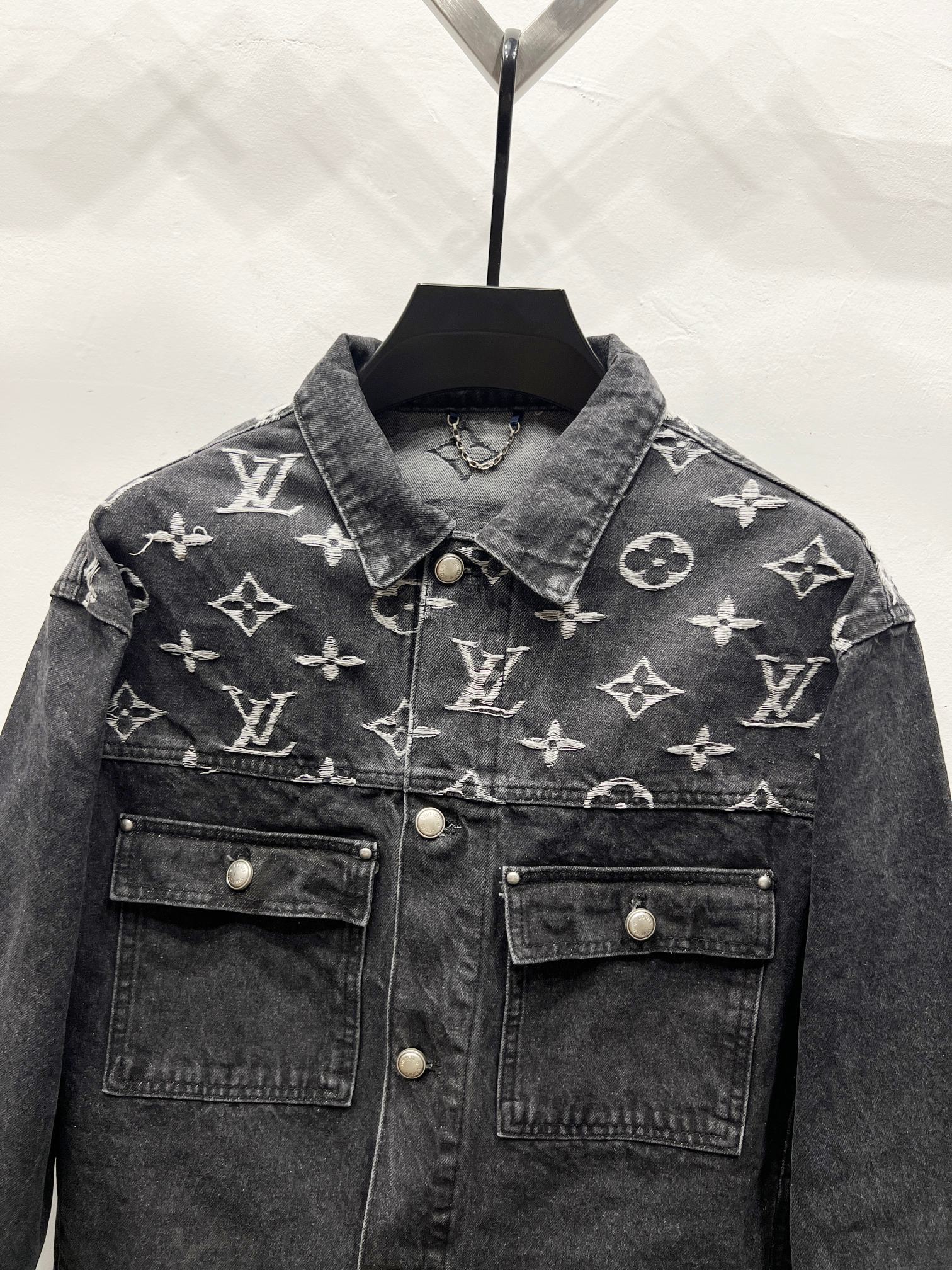 Black denim jacket with LV-style monogram print, spread collar, two chest flap pockets