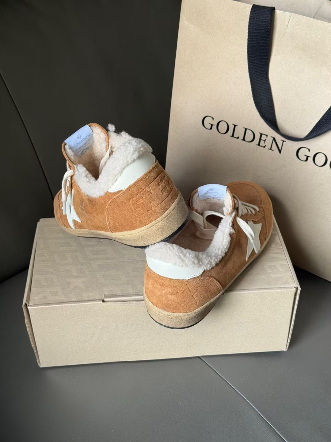 Tan suede high-top sneakers with white star, sherpa lining, and white lace-up closure