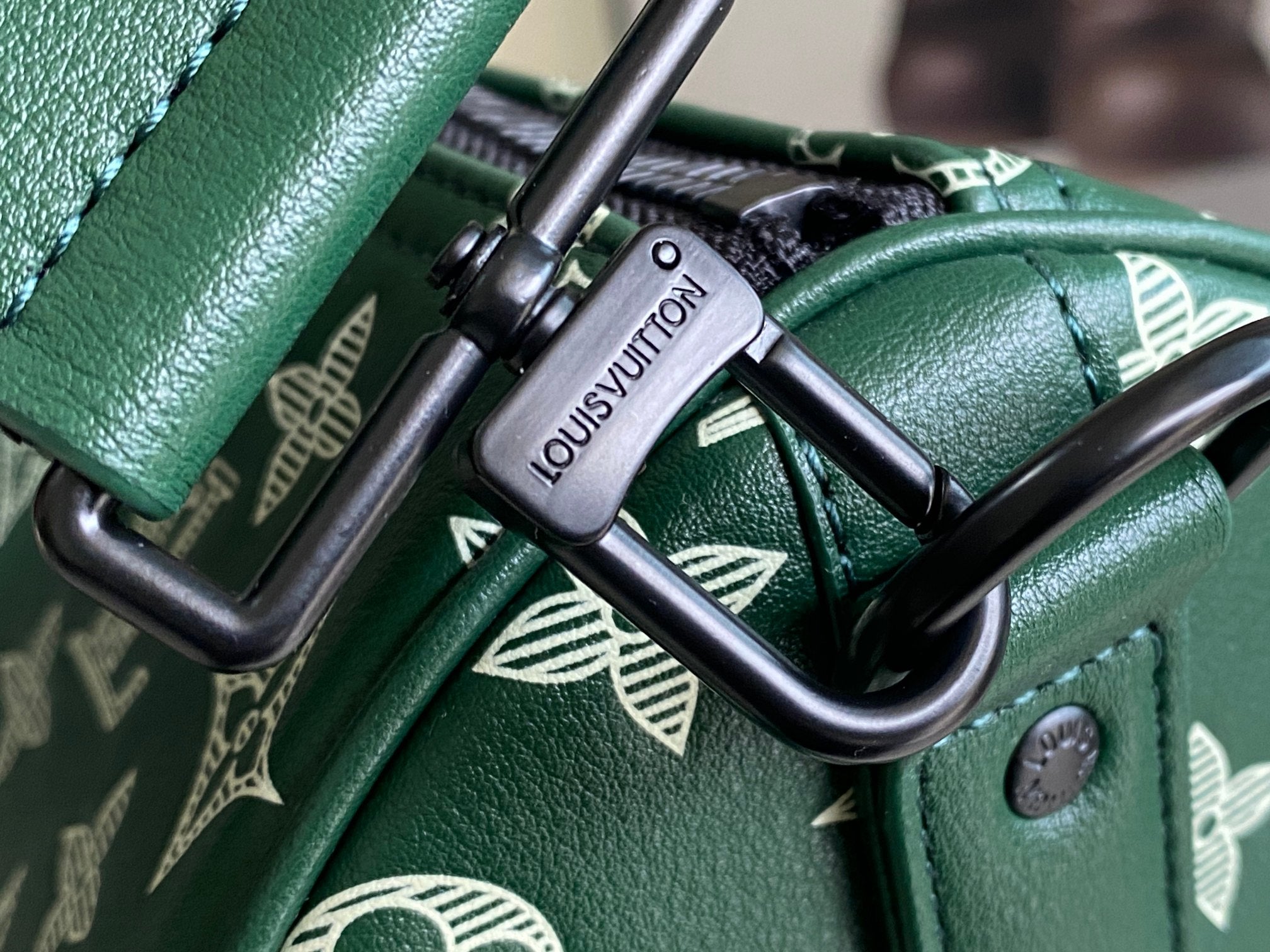 Louis Vuitton green leather bag hardware with black metal clasp and rings