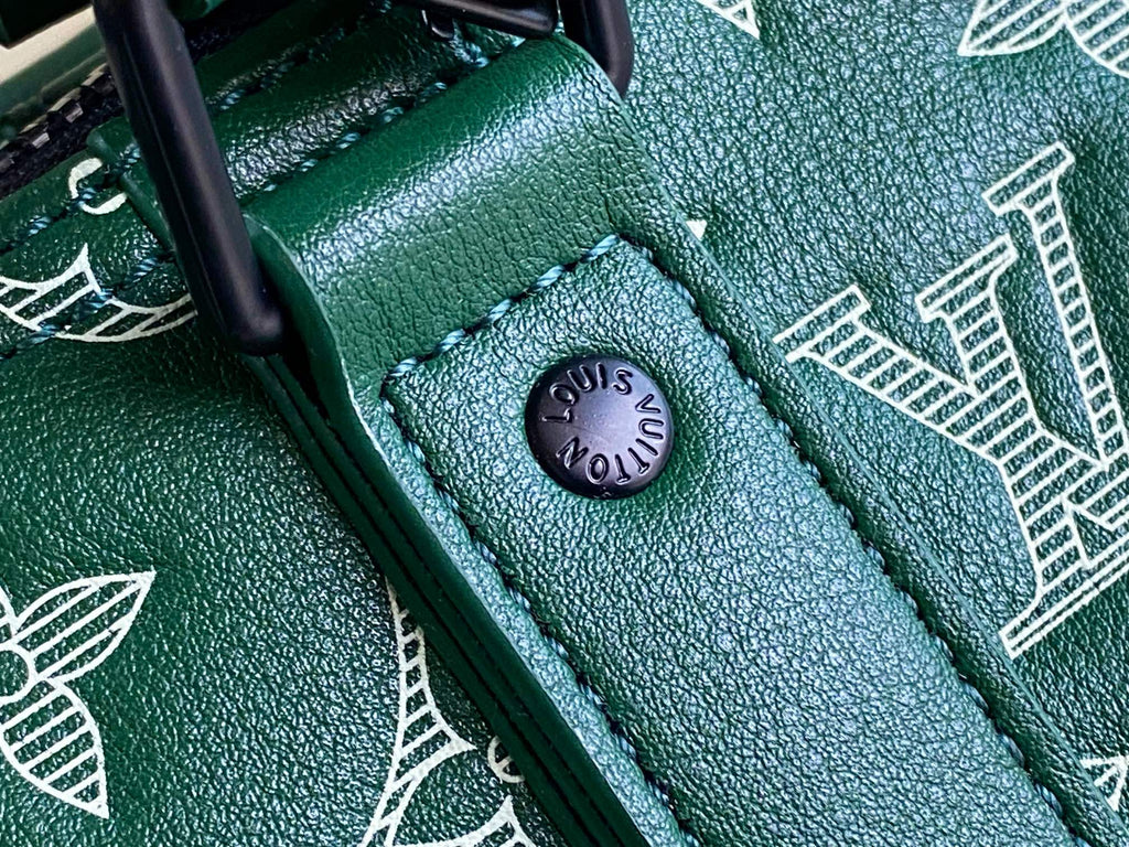 Louis Vuitton green leather clasp tab with black metal ring close-up