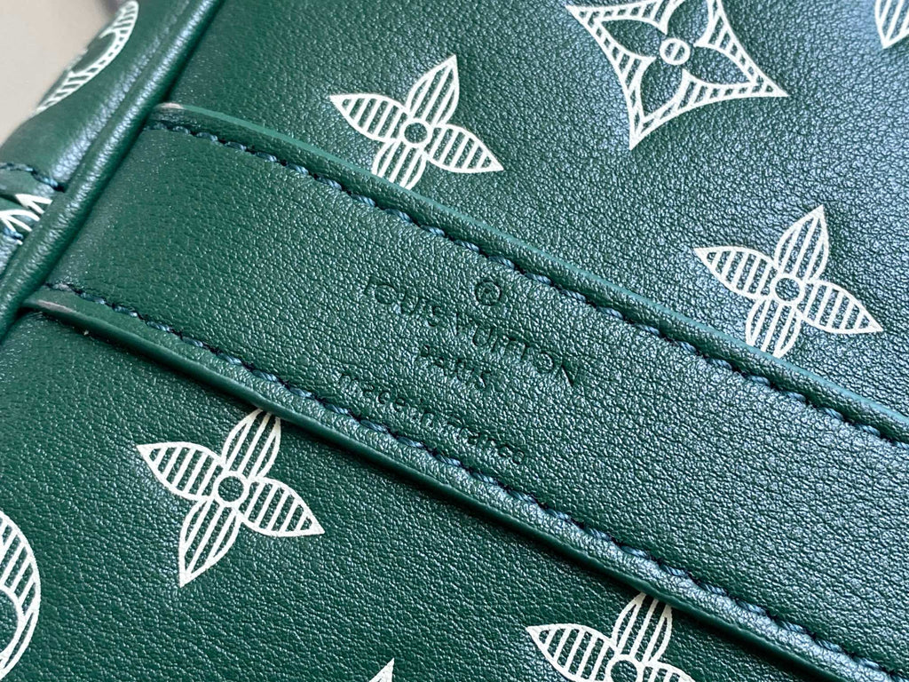 Louis Vuitton green leather stitching detail with white monogram pattern