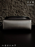 Structured leather crossbody bag with top zipper and shoulder strap