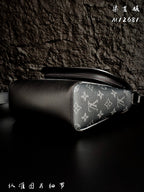 Leather and monogram crossbody bag with side zipper and curved silhouette