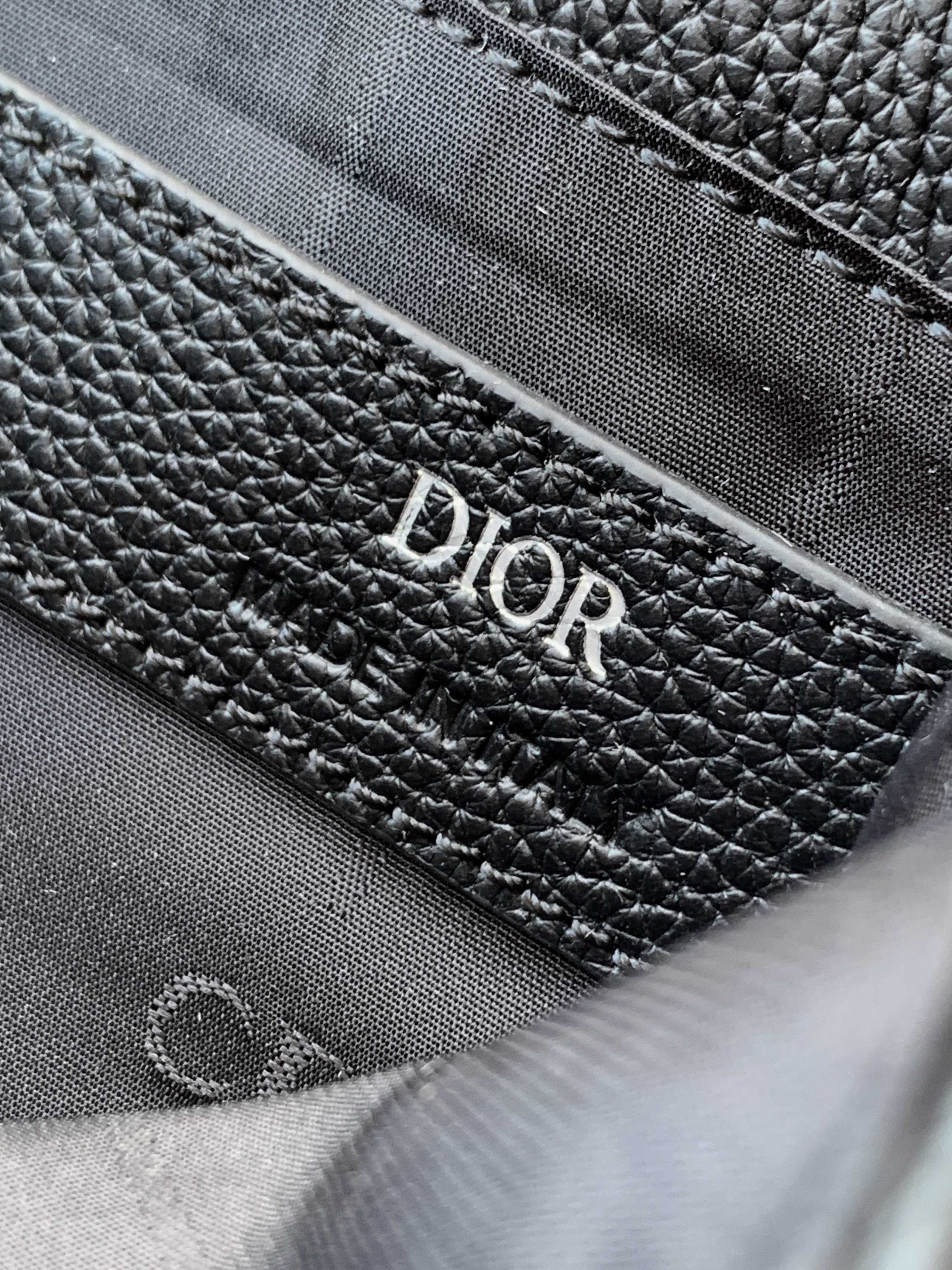 Dior leather bag interior close-up with textured lining and Dior branding