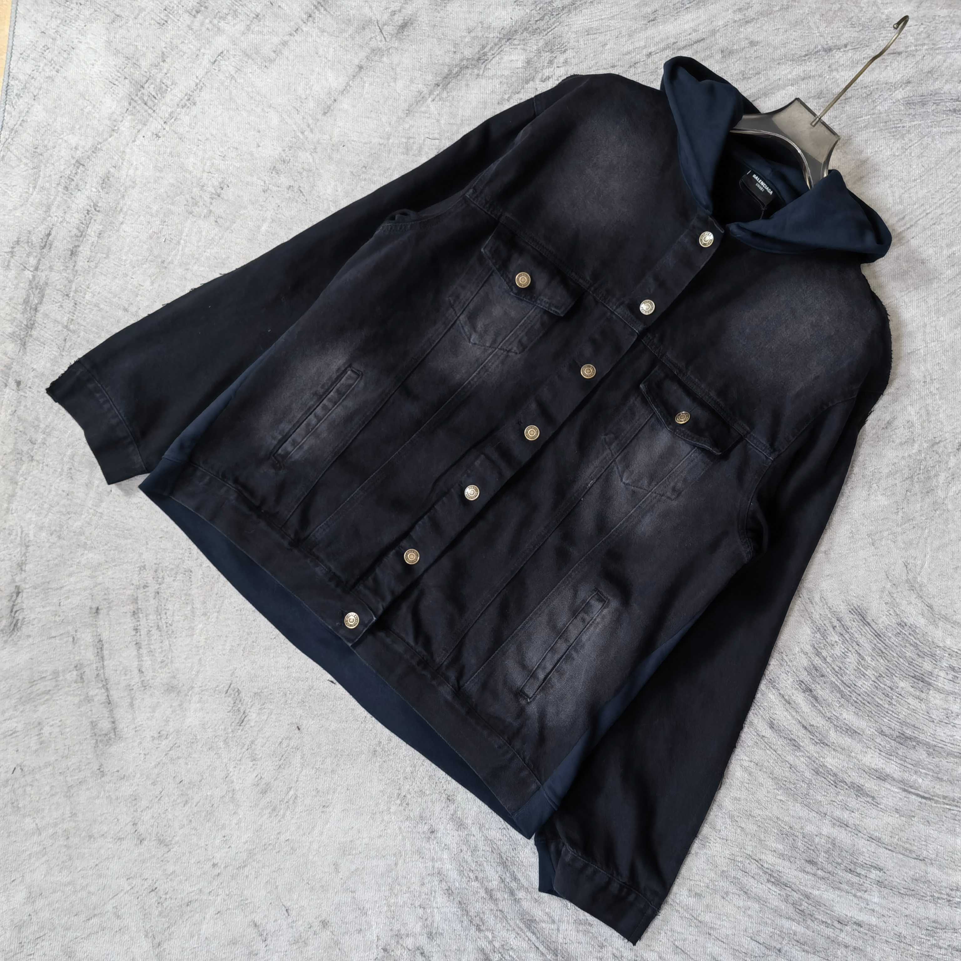 Navy hooded denim jacket with snap front and two chest pockets, laid diagonally.