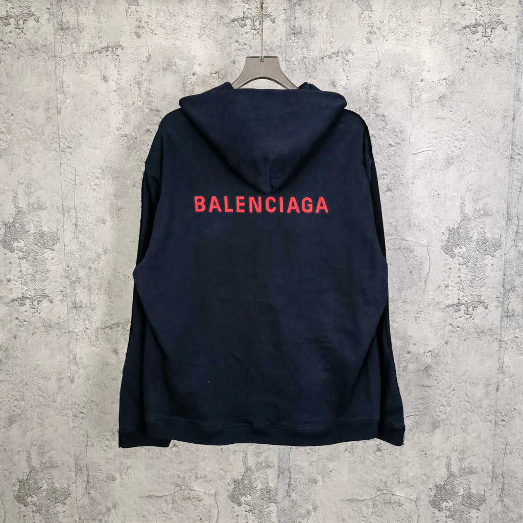 Navy hooded jacket with red BALENCIAGA logo on the back and snap front.
