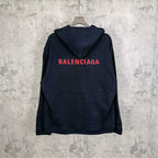 Navy hooded jacket with red BALENCIAGA logo on the back and snap front.