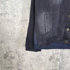 Navy hooded denim jacket hem with stitched pocket panel and snap hardware detail.