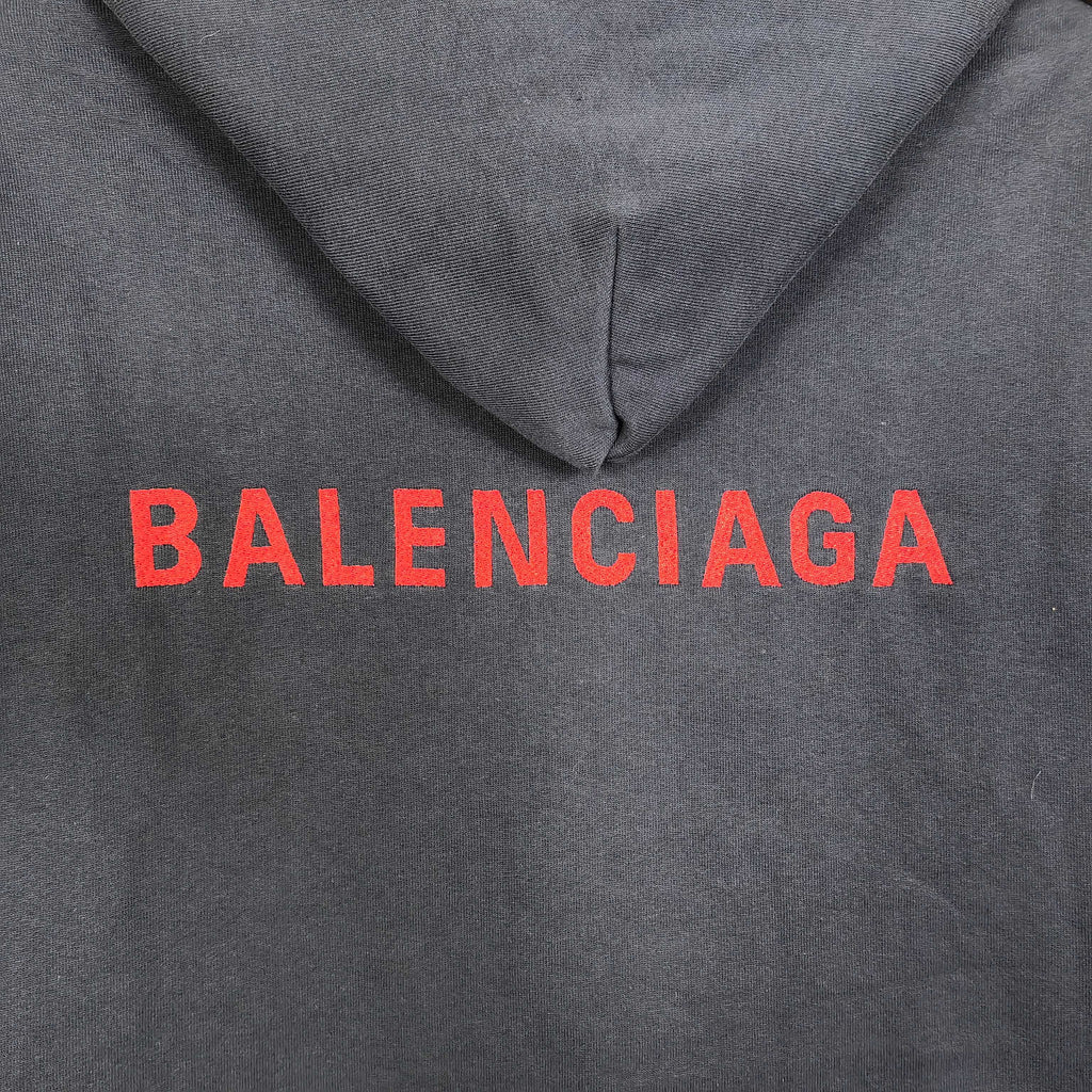 Navy hooded jacket with red BALENCIAGA logo on the chest.