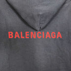 Navy hooded jacket with red BALENCIAGA logo on the chest.