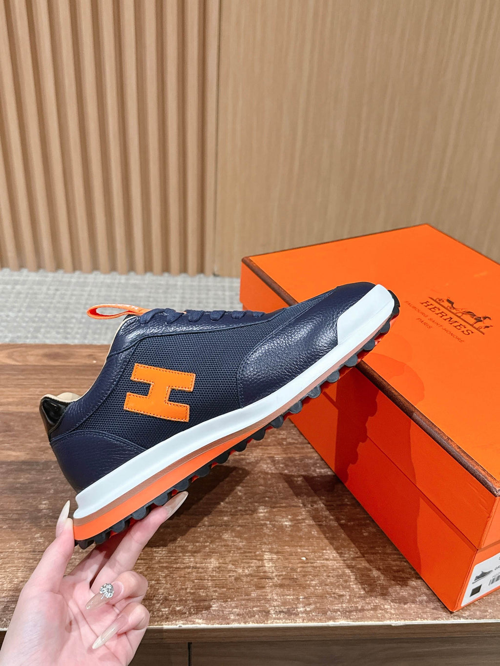 Hermes unisex navy sneakers with bold H logo, lace-up, orange trim, white sole