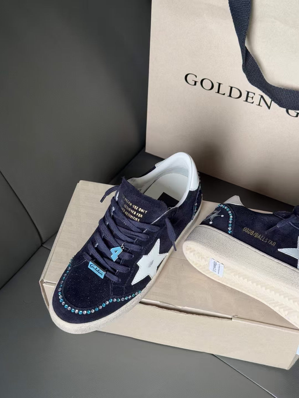 Golden Goose sneakers in dark navy with white star, lace-up, blue accent tag on side