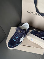 Golden Goose sneakers in dark navy with white star, lace-up, blue accent tag on side