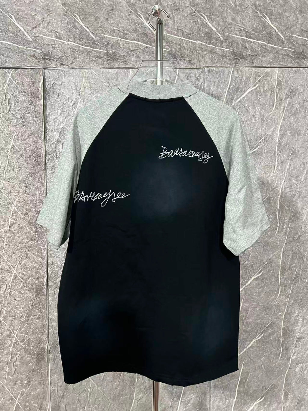Black raglan T-shirt with heather gray raglan sleeves and small chest script
