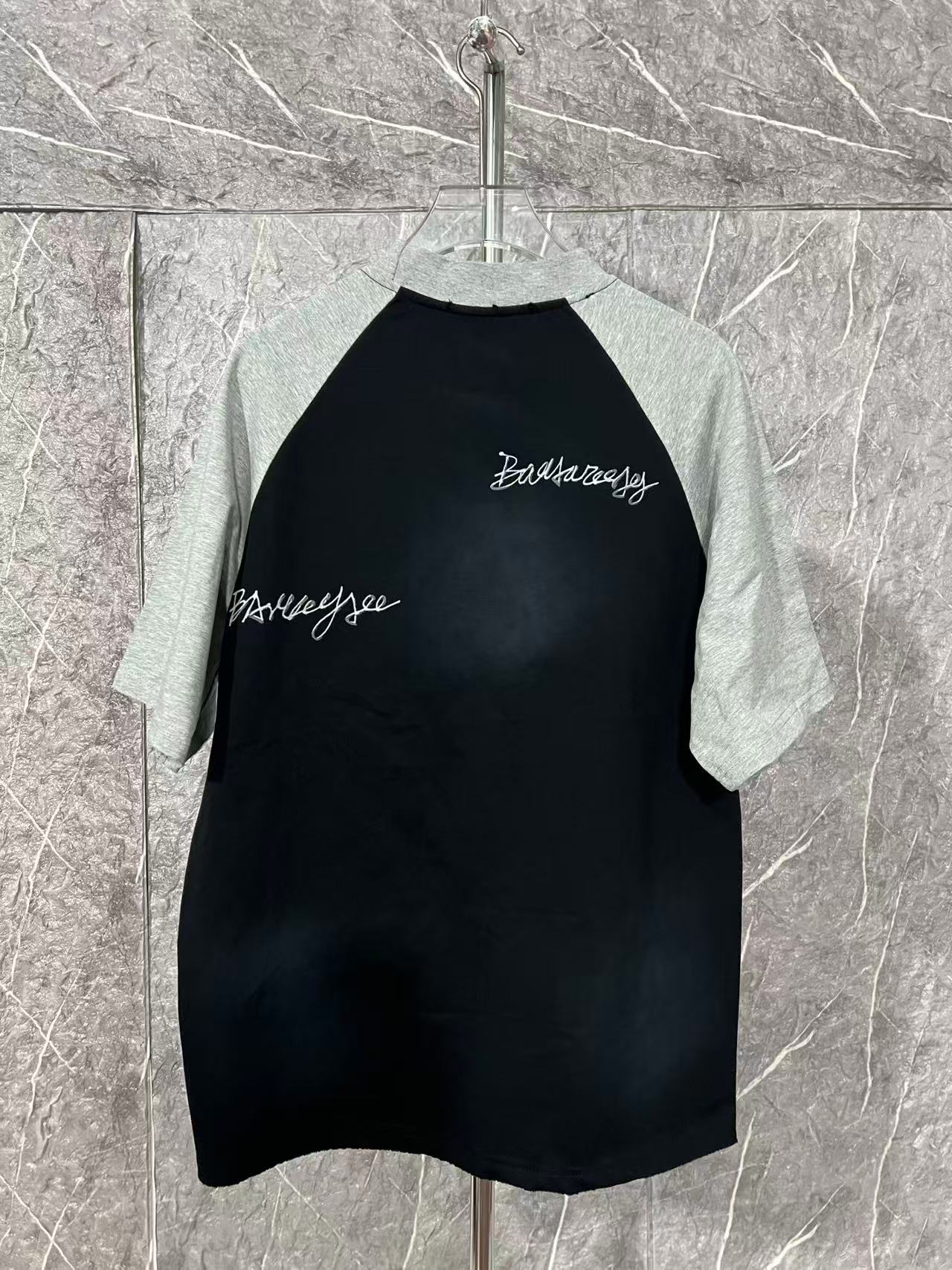 Black raglan T-shirt with heather gray raglan sleeves and small chest script
