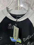 Black raglan T-shirt with heather gray crew neck and hanging tag