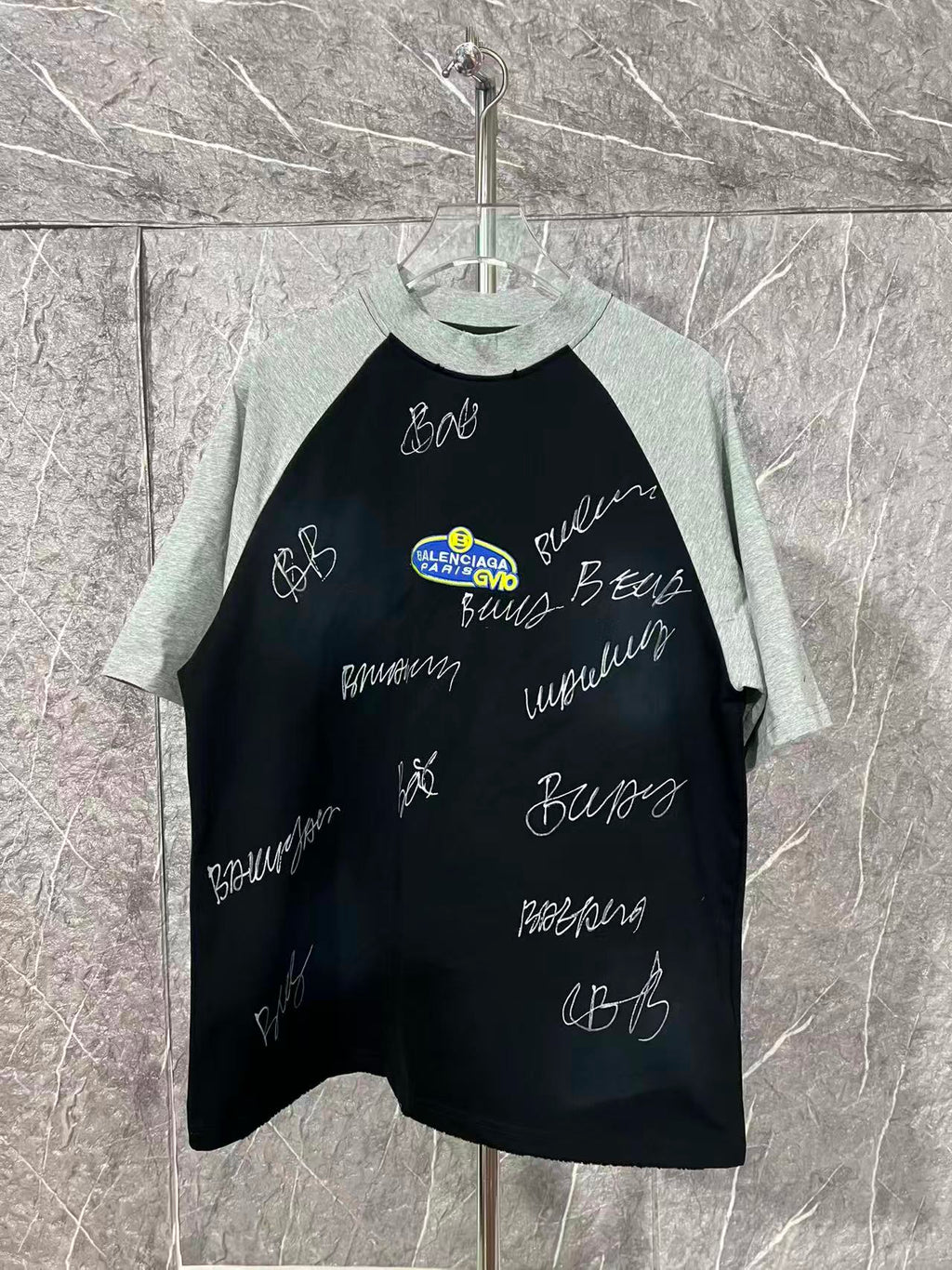 Black raglan T-shirt with heather gray sleeves and handwritten graphic lettering