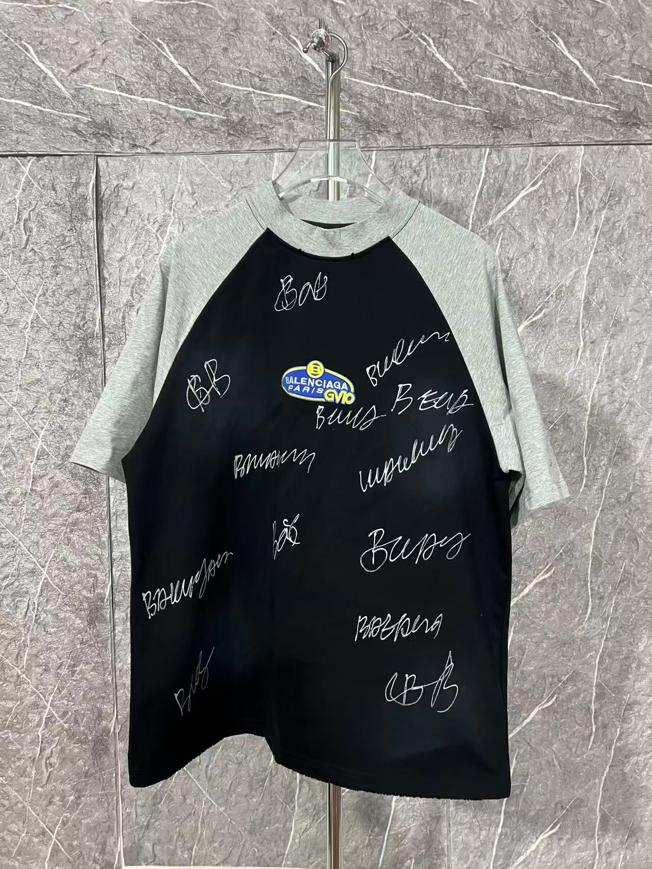 Black raglan T-shirt with heather gray sleeves and handwritten graphic lettering