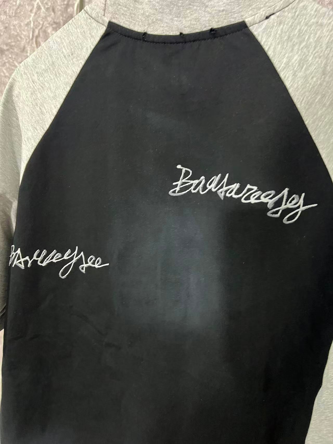 Black raglan T-shirt with cursive logo script on upper back