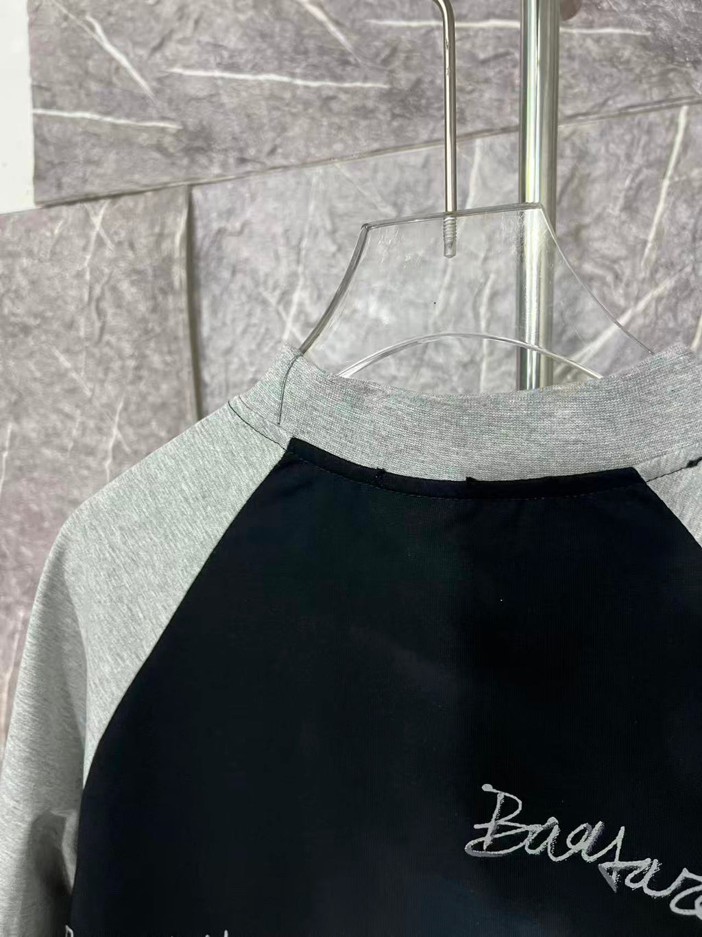 Black raglan T-shirt with heather gray neckline and partial right-side print