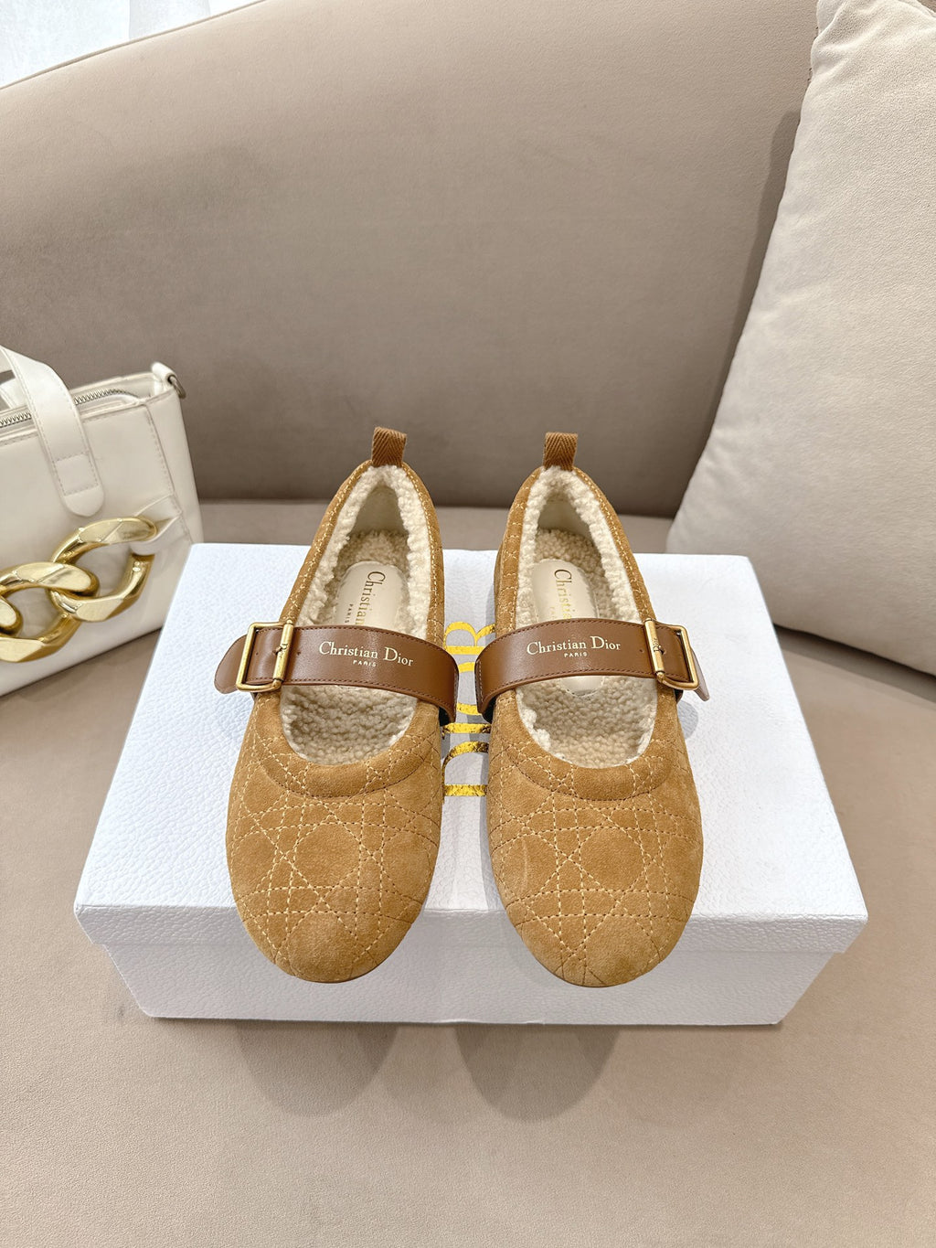 Tan suede flats with buckled strap and cream shearling lining, pair on box
