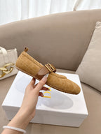 Tan suede flat with buckled strap and cream lining, profile view