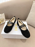 Pair of women's black Dior loafers with gold buckle and shearling-lined interior