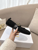 Women's black Dior loafer with gold buckle detail and shearling-lined interior, side view