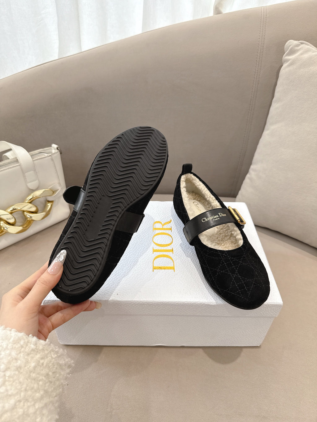 Women's black Dior loafers with rubber sole and gold buckle, underside view