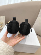 Women's black Dior loafers back view with gold-tone buckle hardware