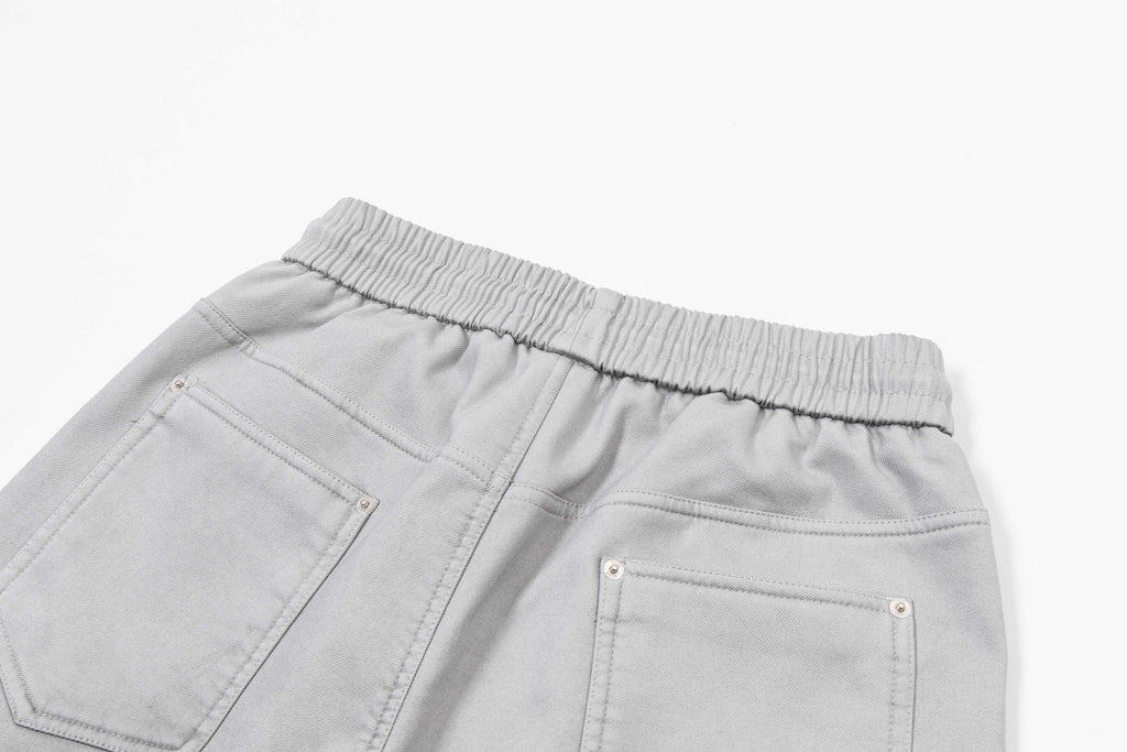 Light gray denim-style pants with elastic waist and stitched pockets