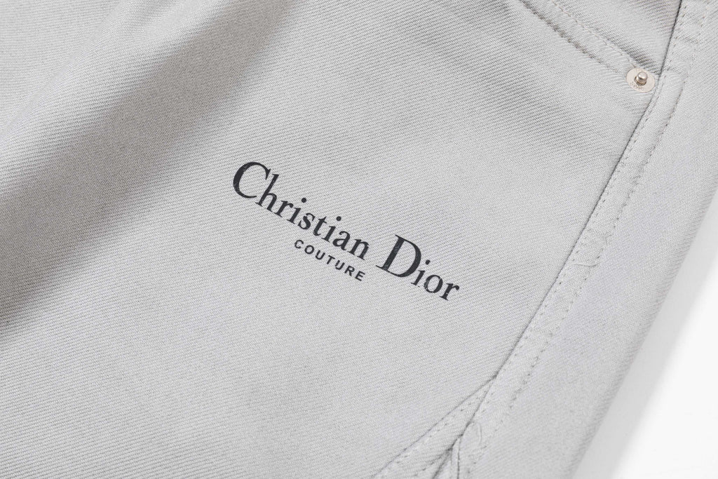 Light gray pants leg with embroidered Christian Dior logo