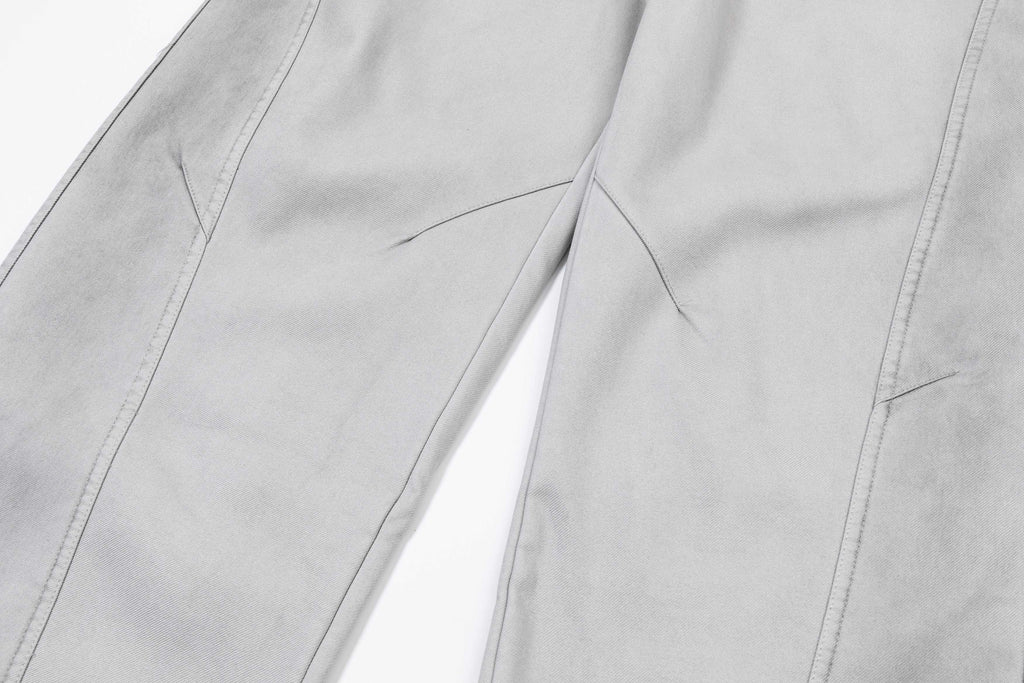 Light gray pants close-up of stitched seams and leg panels