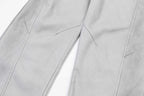 Light gray pants close-up of stitched seams and leg panels