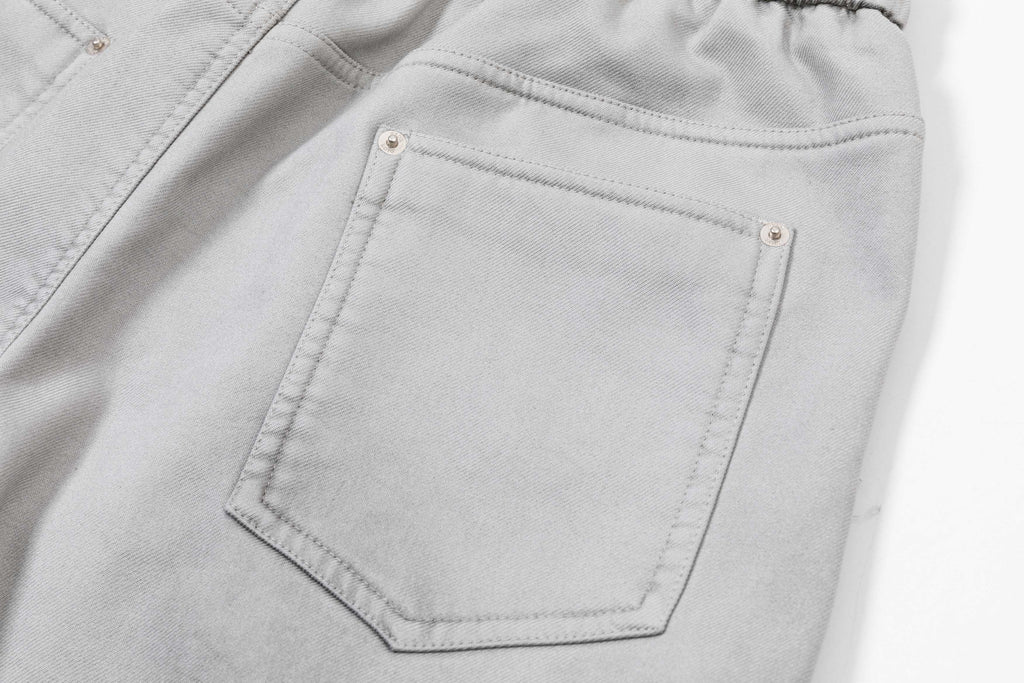 Light gray pants with front patch pocket and visible topstitching