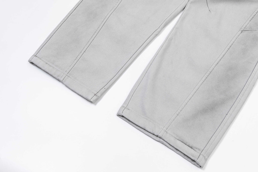 Light gray pants with straight hems and visible side seam stitching