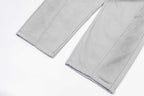 Light gray pants with straight hems and visible side seam stitching