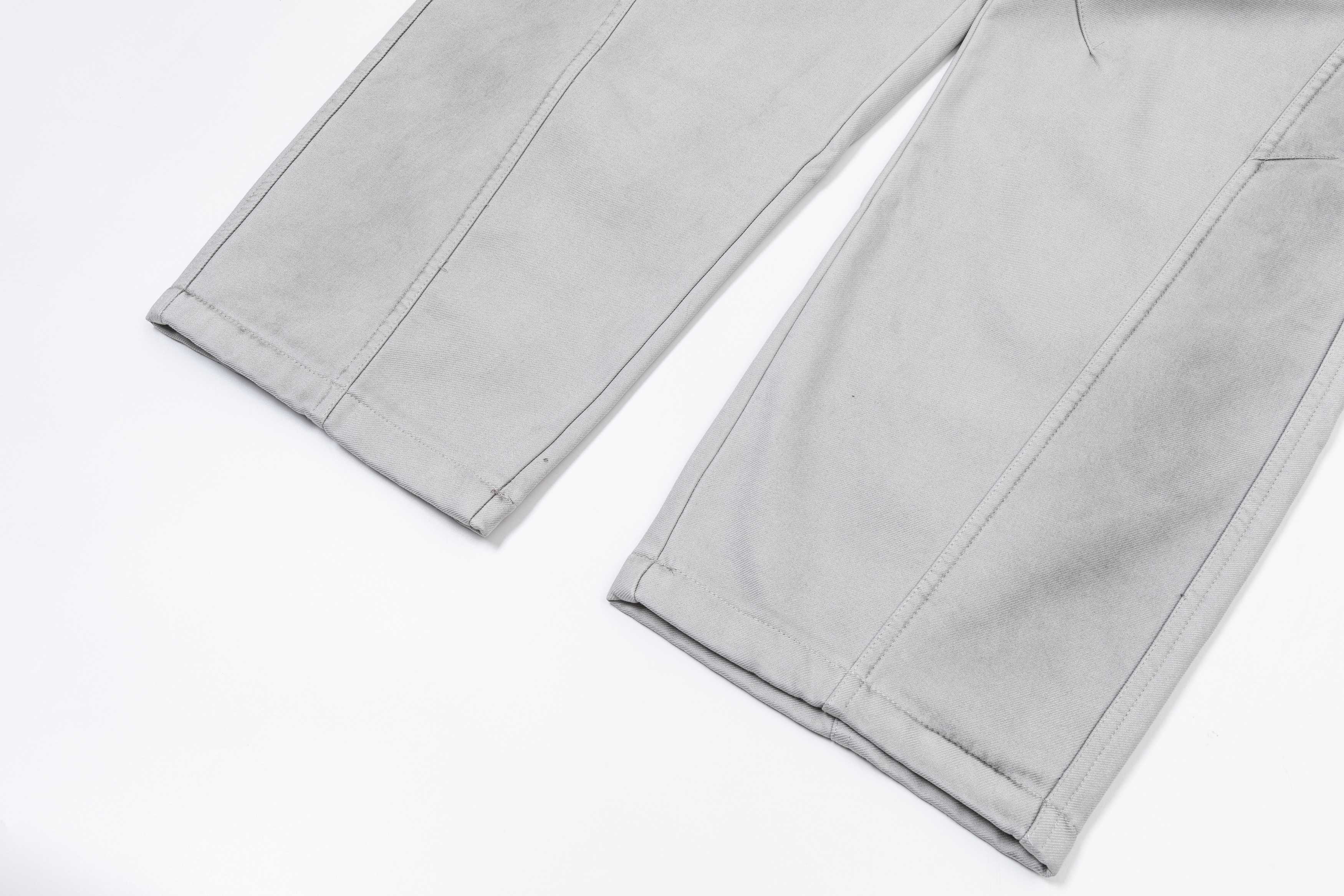 Light gray pants with straight hems and visible side seam stitching