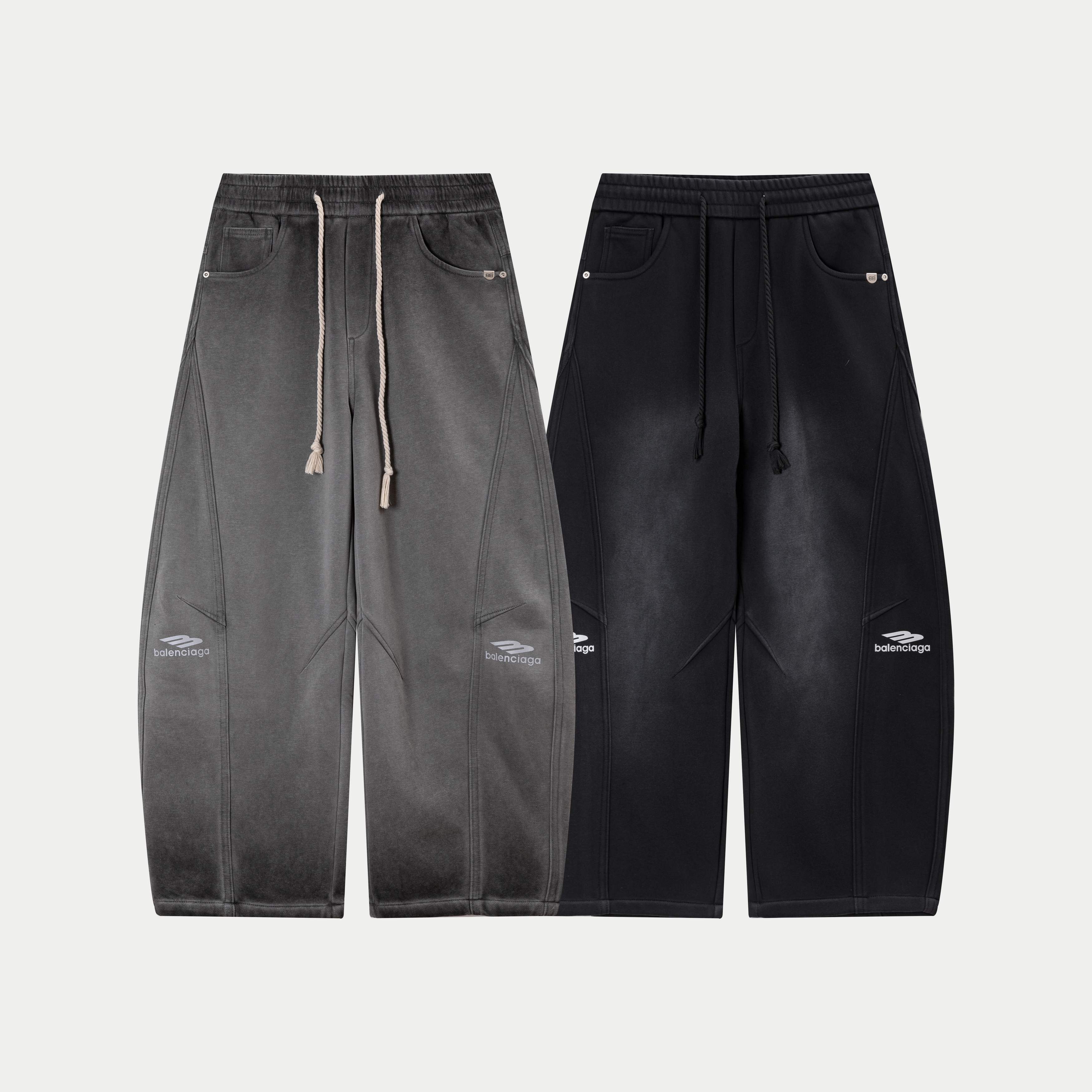 Gray and black drawstring waist pants with matching pocket and logo accents