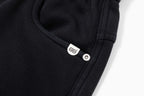 Black pants with logo metal button detail on drawstring fly
