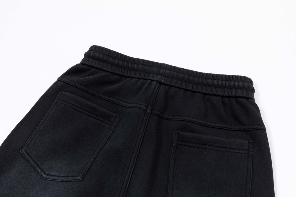 Black elastic waistband pants with front pockets and stitched seams