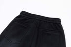 Black elastic waistband pants with front pockets and stitched seams