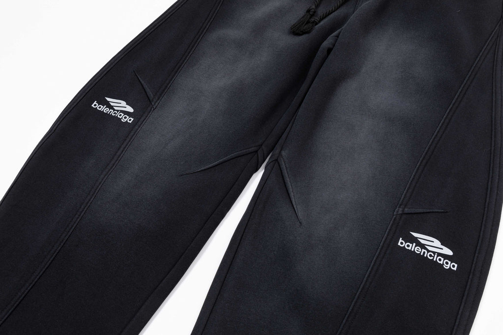 Black pants close-up showing front seams, pockets, and Balenciaga logos