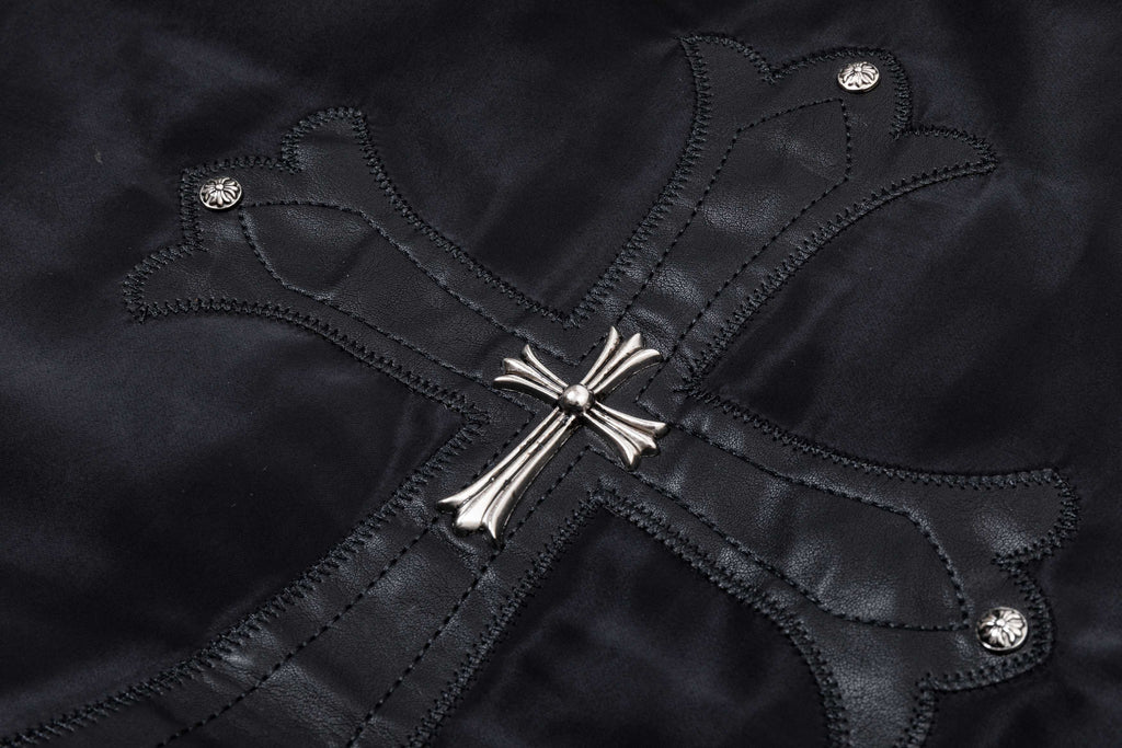 Black bomber jacket with stitched cross design and silver snap buttons