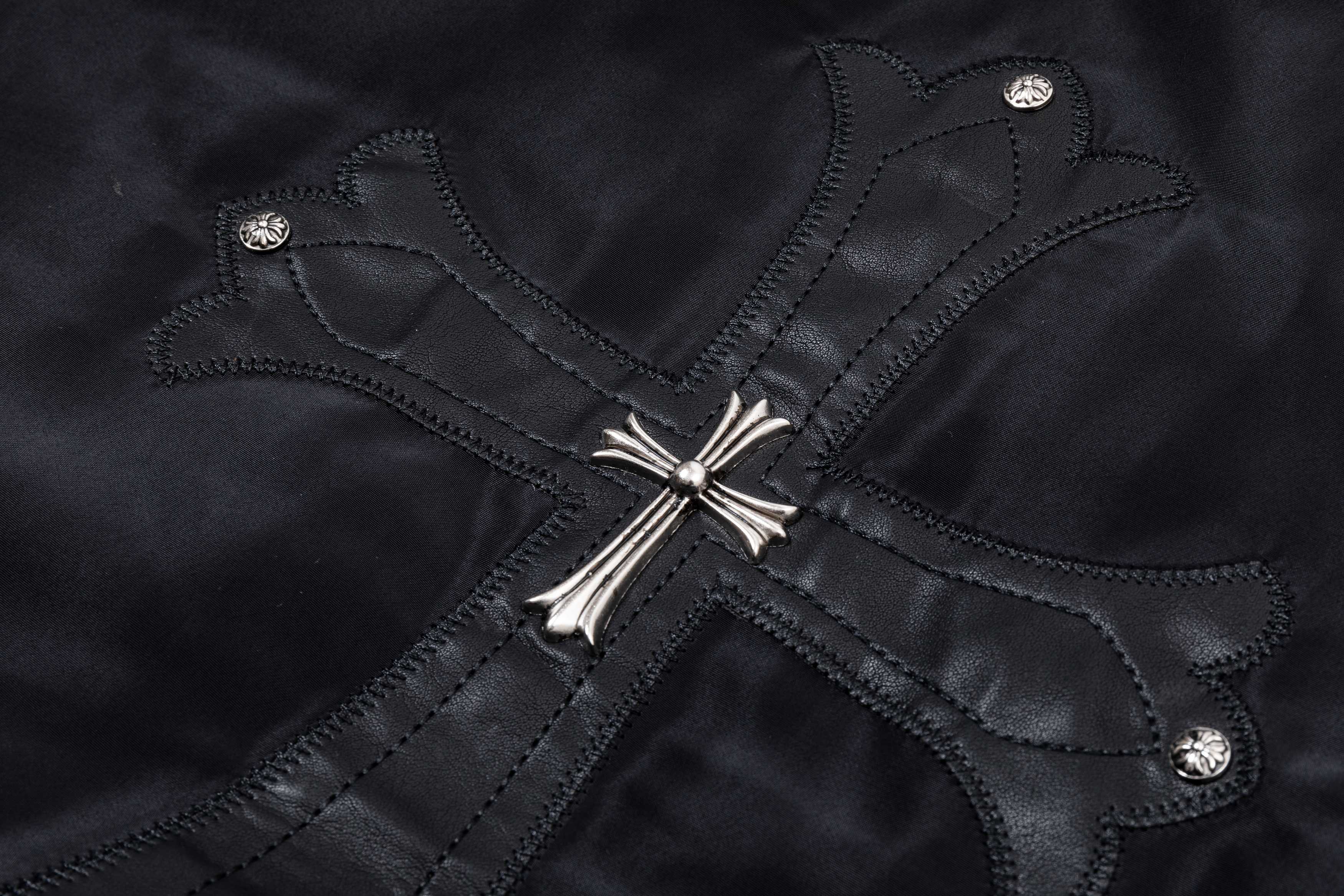 Black bomber jacket with stitched cross design and silver snap buttons