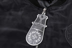 Black bomber jacket neck tag with zipper pull and metal hardware