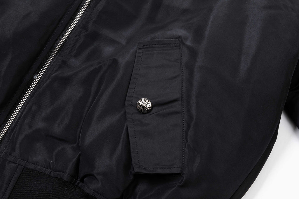 Black bomber jacket sleeve pocket with snap button and gathered cuff