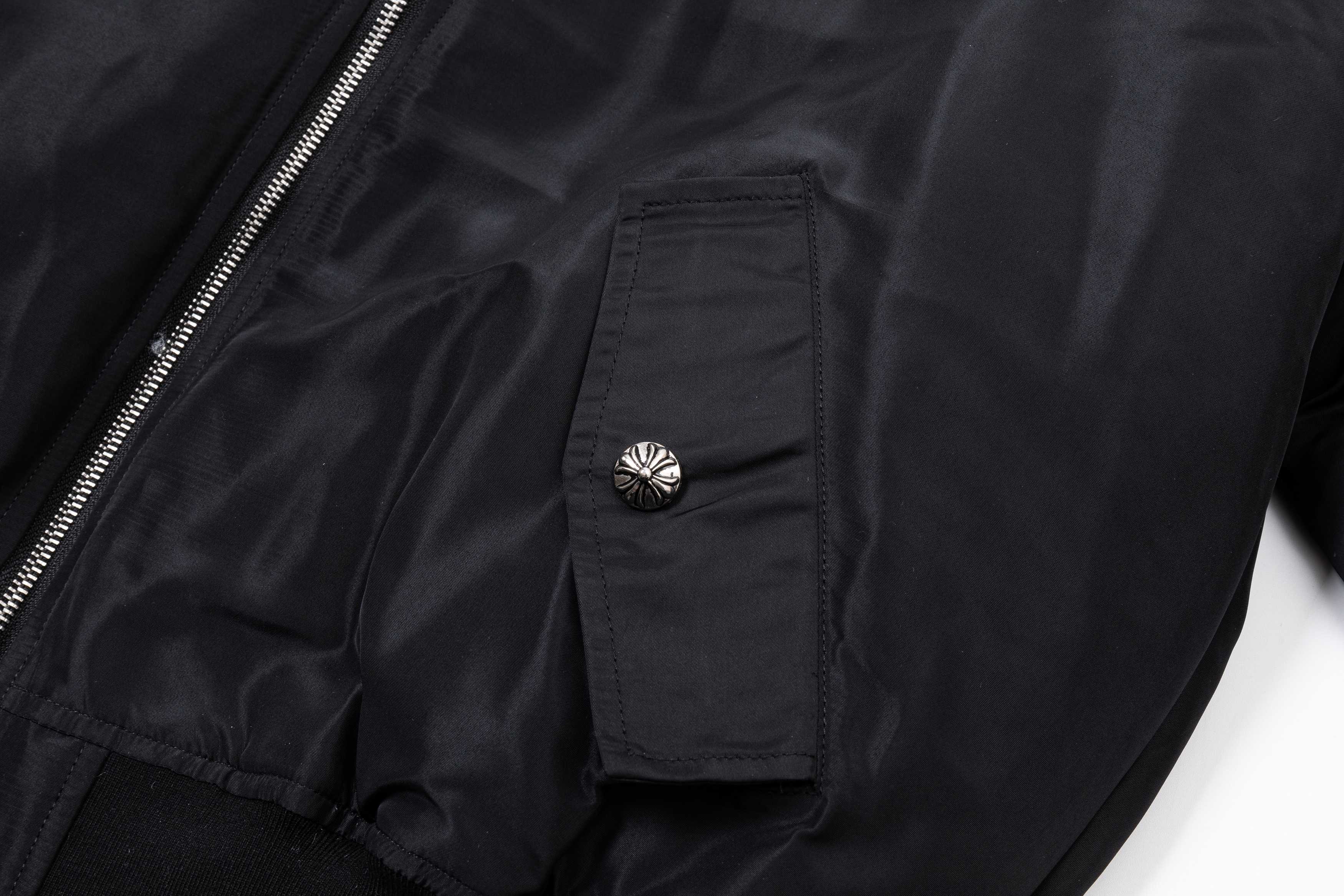Black bomber jacket sleeve pocket with snap button and gathered cuff